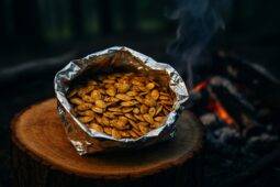 Spiced pumpkin seeds inside a foil packet ready for cooking over a campfire.