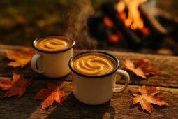 Savory pumpkin pudding bubbling in a pot over campfire coals, ready to serve.
