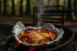 Cooked sausage, peppers, onions, and eggs mixed together in a foil packet for easy campfire cooking.